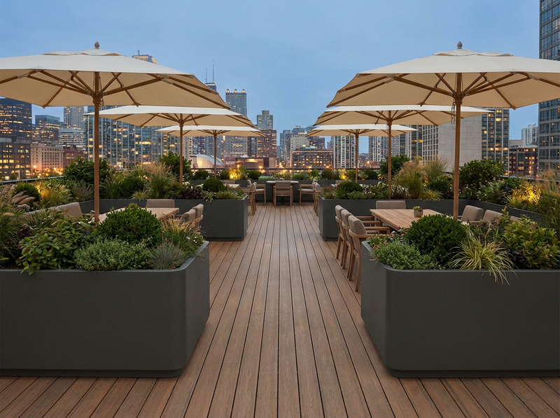 Outdoor rooftop deck with umbrellas, tables, and city skyline